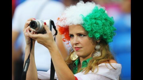 An Irish fan attempts to catch a snapshot of the action ahead of match between Italy and Ireland.