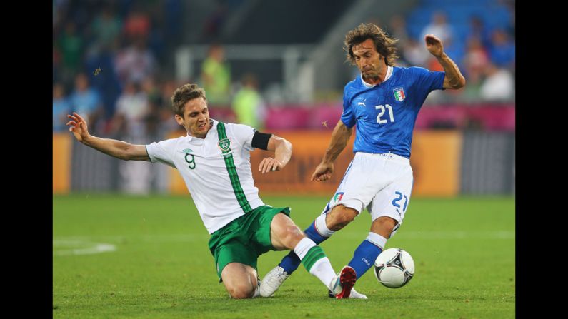  Kevin Doyle of Ireland tackles Andrea Pirlo of Italy.