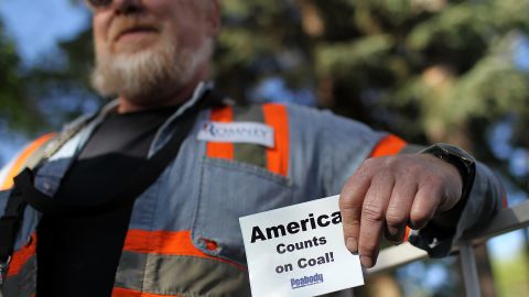  A coal miner holds a sign during a campaign rally for Republican presidential candidate Gov. Mitt Romney in Craig, Colorado. 