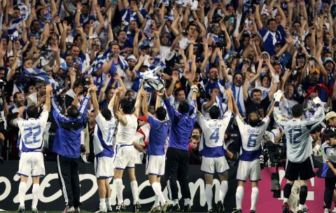 Greece's triumphant Euro 2004 squad parade the trophy in front of their adoring fans.