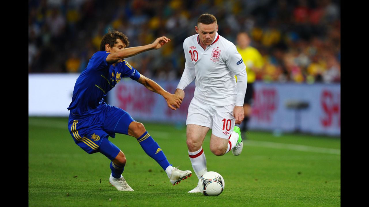 Wayne Rooney of England breaks past Denys Harmash of Ukraine during Tuesday's match in Donetsk, Ukraine.