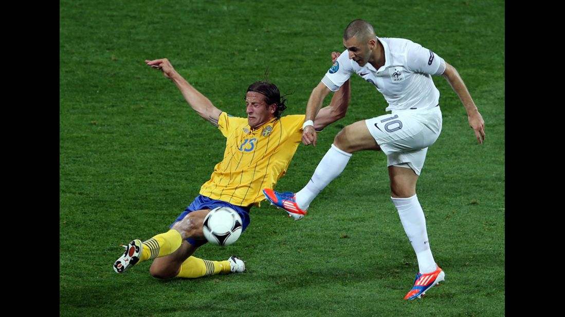 Karim Benzema of France is challenged by Jonas Olsson of Sweden during the match between Sweden and France.