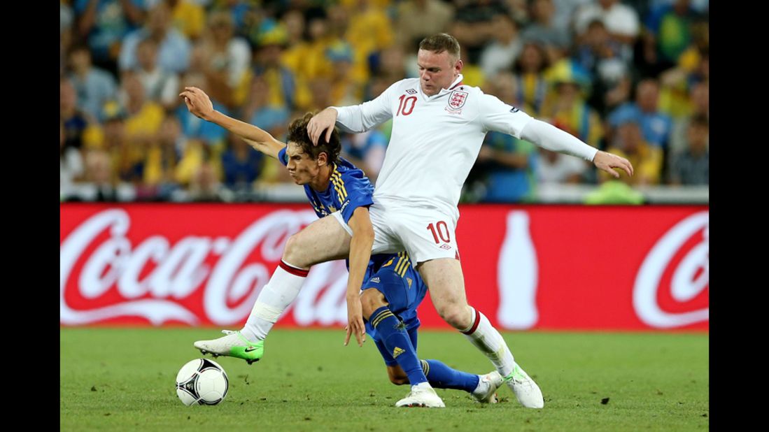 Wayne Rooney of England clashes with Denys Garmash of Ukraine during the match between England and Ukraine.