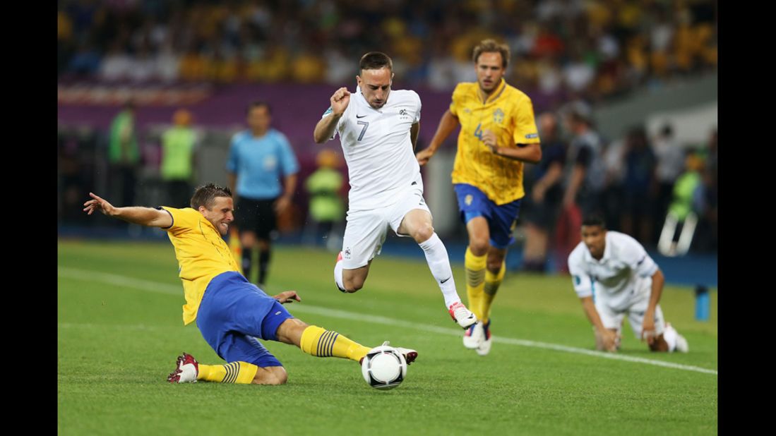 Franck Ribery of France is tackled by Anders Svensson of Sweden during the match between Sweden and France.