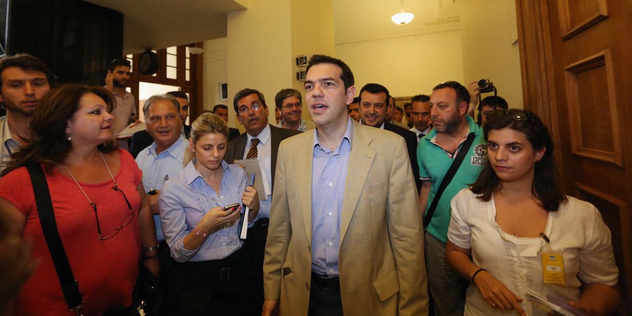 Syriza leader Alexis Tsipras walks in parliament after a meeting with New Democracy party leader Antonis Samaras.