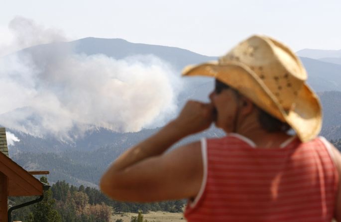 Jessie Couillard watches the High Park Fire a few miles from her house in Glacier View Meadows, northwest of Fort Collins, on Monday, June 18. The lightning-ignited wildfire that started June 9 has destroyed nearly 200 homes.