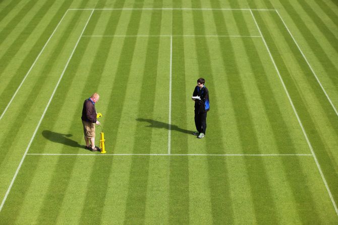 Wimbledon ground staff conduct a test to determine how the ball is bouncing on a court.