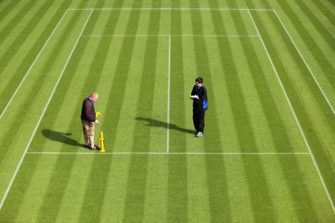 Wimbledon ground staff conduct a test to determine how the ball is bouncing on a court. 