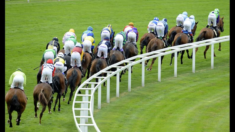 Runners take the bend away from the grandstand at Ascot racecourse.
