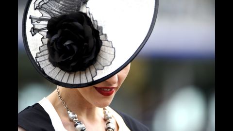 A woman in a striking hat attends day one of the races.