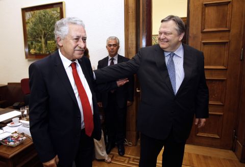 Venizelos, right, shakes hands with the leader of the Democratic Party of the Left, Fotis Kouvelis, at the Greek parliament on June 19, 2012.  Venizelos said discussions would continue Wednesday into the exact makeup of the new government. 