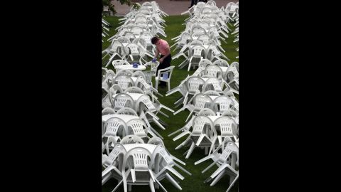 A worker attempts to dry tables and chairs at a Champagne bar on Ladies Day at Royal Ascot.