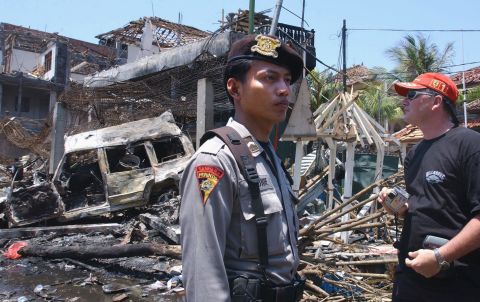 Immediately after the blasts, more than 400 people were reported missing, according to Australian Federal Police. In the following months, the death toll was confirmed at 202, including 88 Australians. A tourist looks at the destroyed building of what remains of Paddy's Bar the day after the attack.