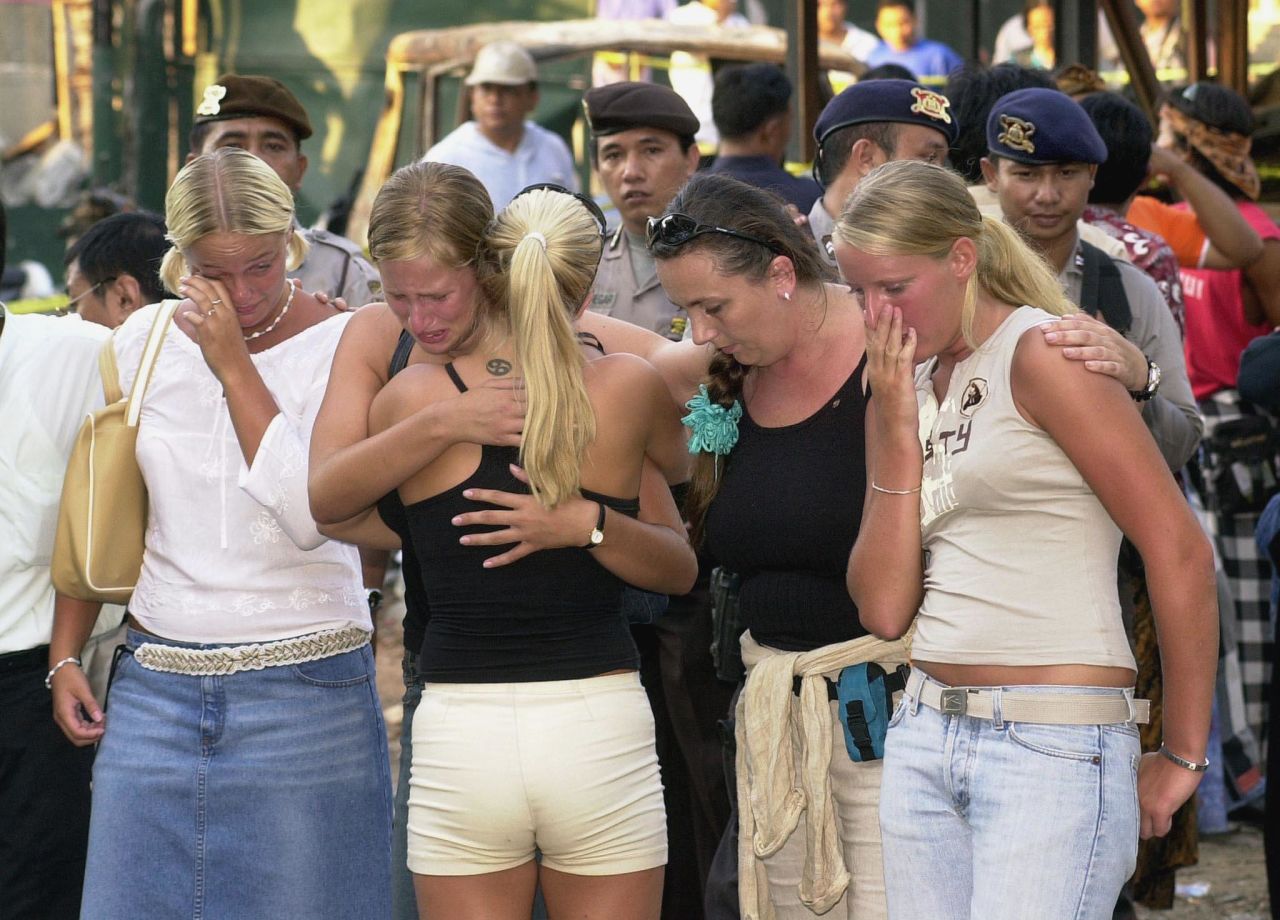 Several Australian women hug each other as they visit the blast site in the tourist area of Kuta, near Denpasar, on October 17, 2002. 