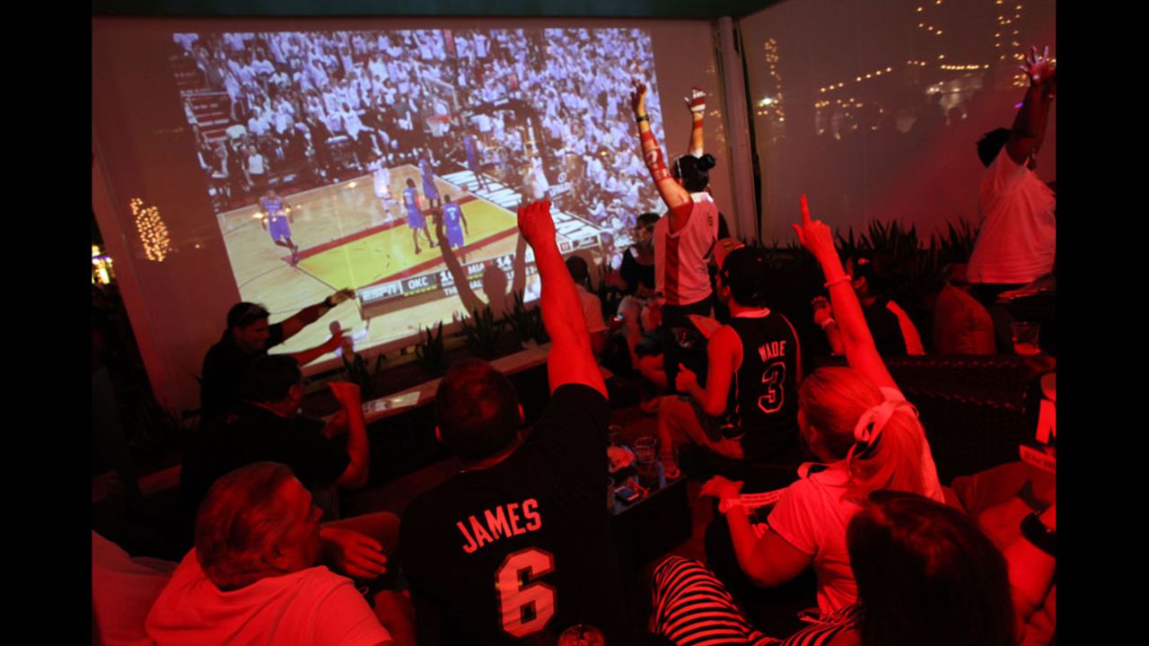 Fans watch game five of the 2012 NBA finals between the Oklahoma City Thunder and Miami Heat at Havana Nines in Miami.