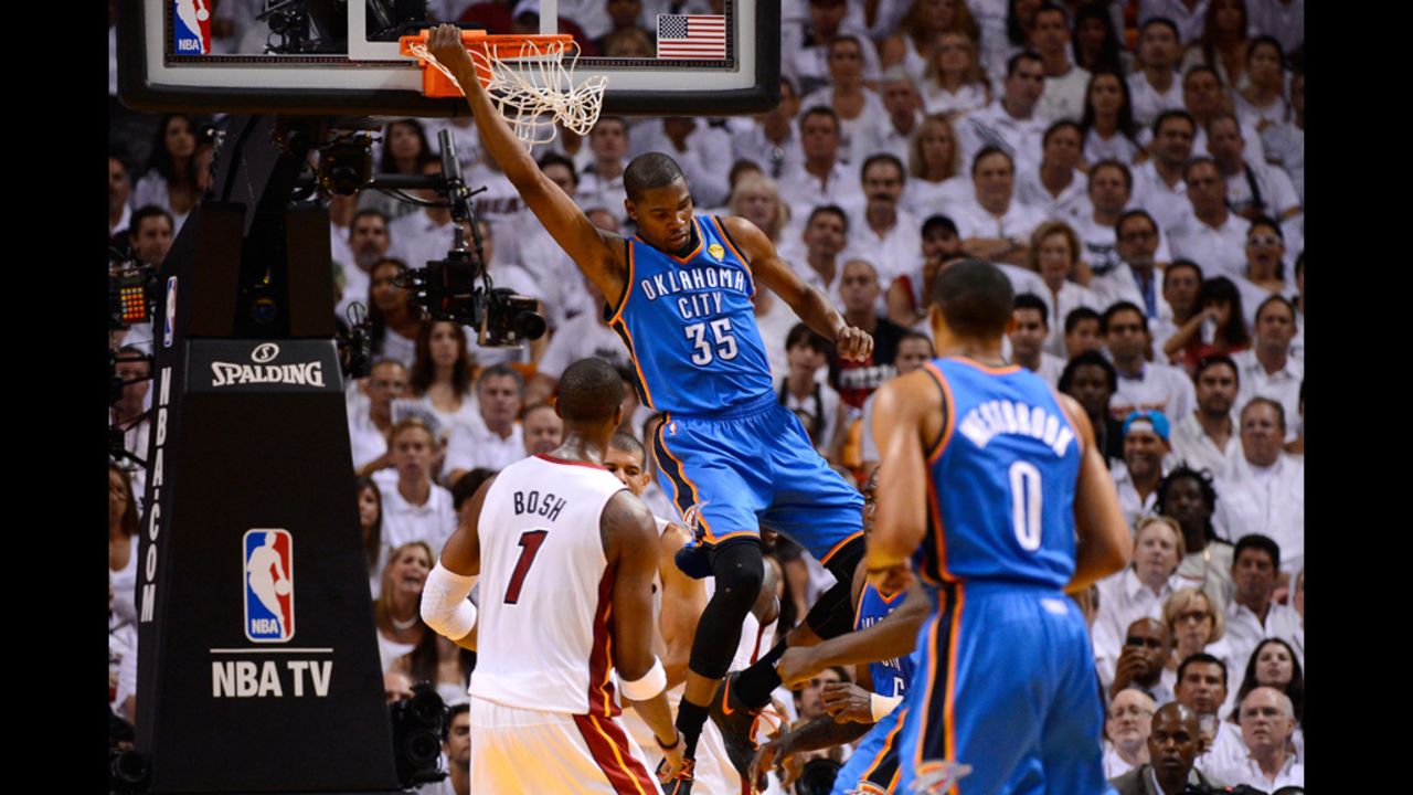 Kevin Durant, No. 35 of the Thunder, hangs on the rim after a dunk in the first half against the Heat. View photos from <a href="http://www.cnn.com/2012/06/19/us/gallery/nba-finals-game-iv/index.html">Game four of the NBA Finals</a>.