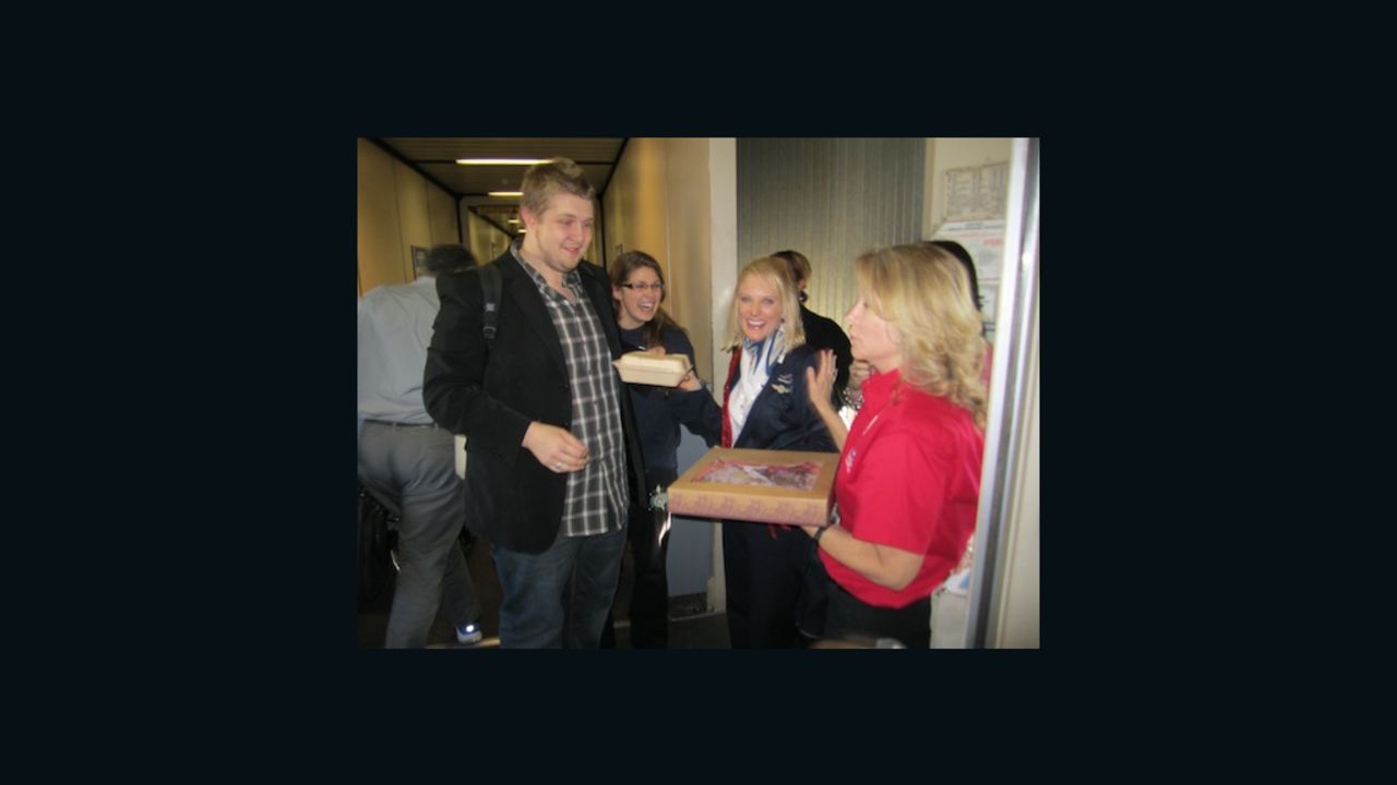 Southwest Airlines flight attendant Holly Hansen being presented with a cookie cake of appreciation.