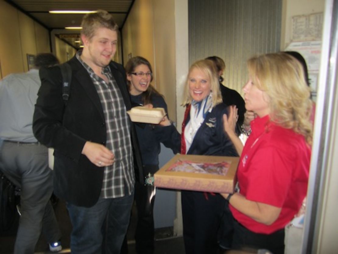 Southwest Airlines flight attendant Holly Hansen being presented with a cookie cake of appreciation.