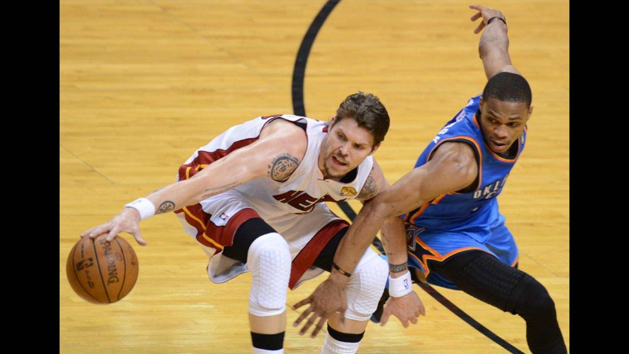 Mike Miller, left, of the Heat is guarded by Russell Westbrook, right, of the Thunder.