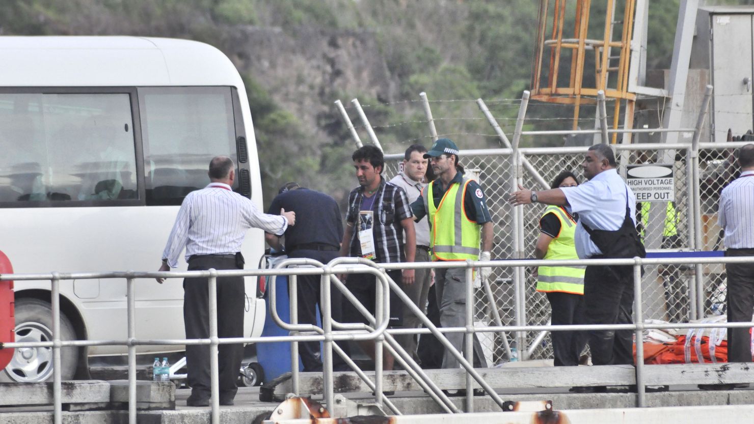 Rescued suspected asylum seekers arrive at Christmas Island after their boat capsized, on June 22.