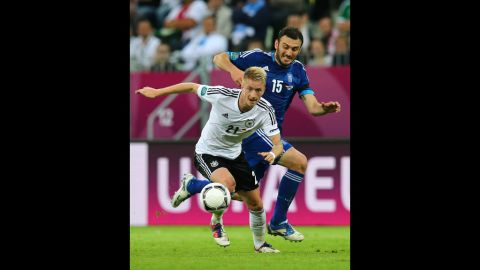 Vasilis Torosidis of Greece shadows Marco Reus of Germany during their Euro 2012 quarterfinal match in Gdansk, Poland.
