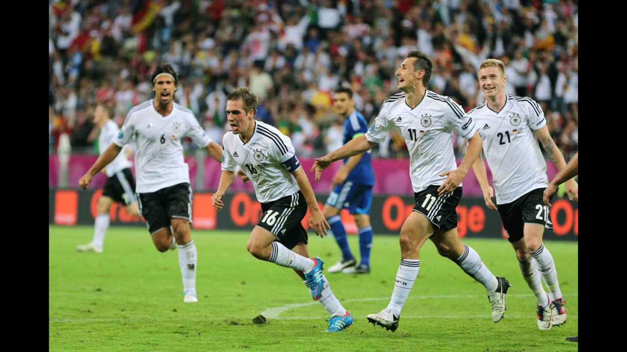 Philipp Lahm, Marco Reus and Miroslav Klose celebrate a goal that put Germany ahead of Greece 1-0 in Friday's quarterfinal match.
