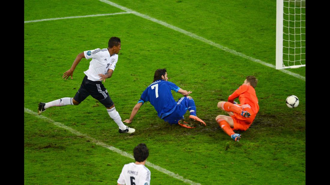 Georgios Samaras scores Greece's first goal past German goalkeeper Manuel Neuer.