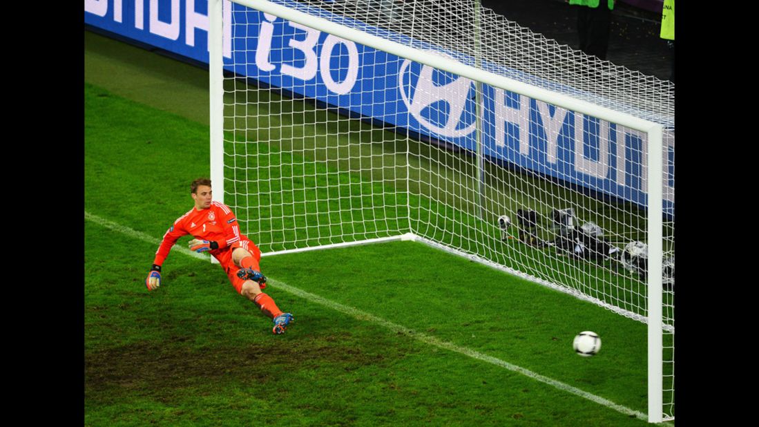 Manuel Neuer of Germany dives the wrong way as Dimitris Salpigidis of Greece (not pictured) scores from the penalty spot during the quarterfinal match between Germany and Greece.