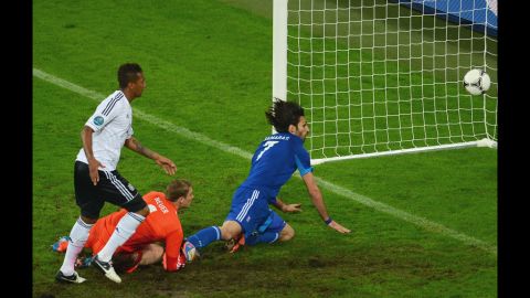 Georgios Samaras of Greece scores the team's first goal past Manuel Neuer of Germany.