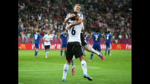Sami Khedira of Germany celebrates scoring the team's second goal with Bastian Schweinsteiger of Germany against Greece.