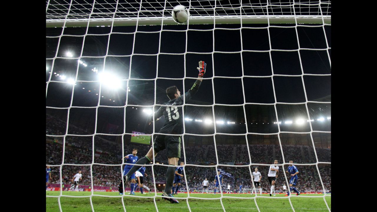 Sami Khedira of Germany scores the team's second goal past Michalis Sifakis of Greece.