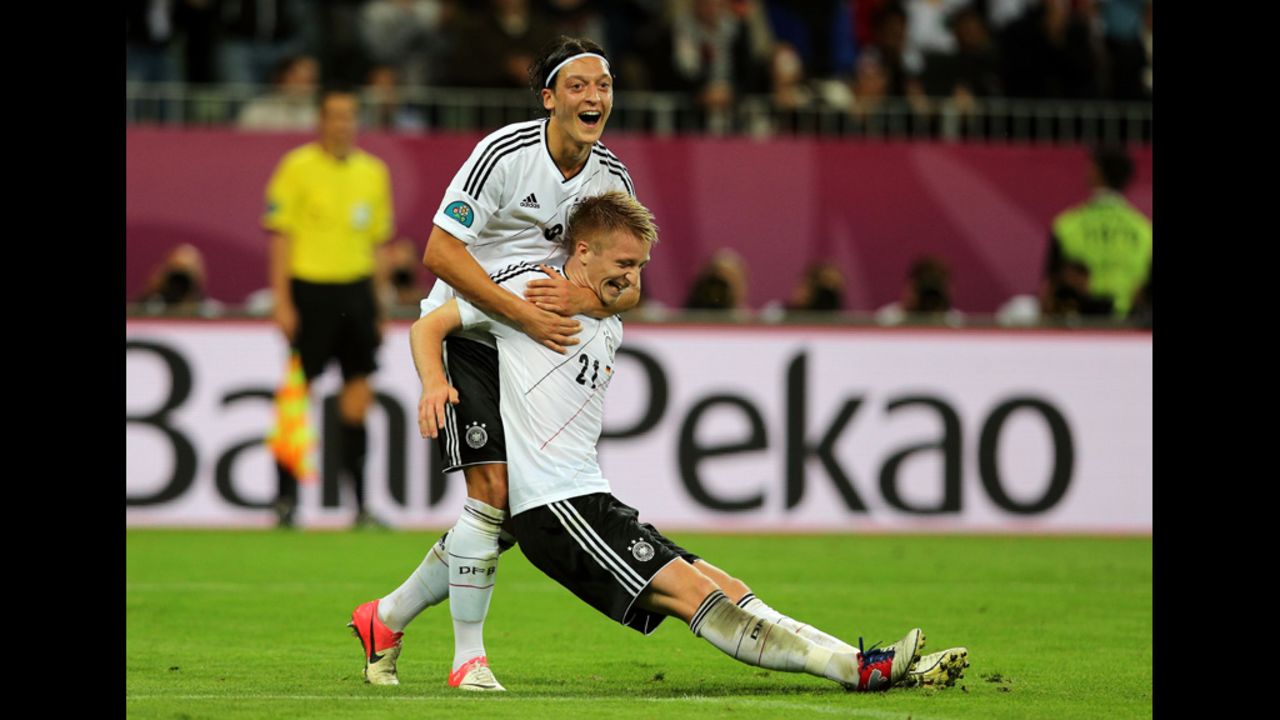 Marco Reus of Germany celebrates scoring the team's fourth goal with Mesut Ozil.