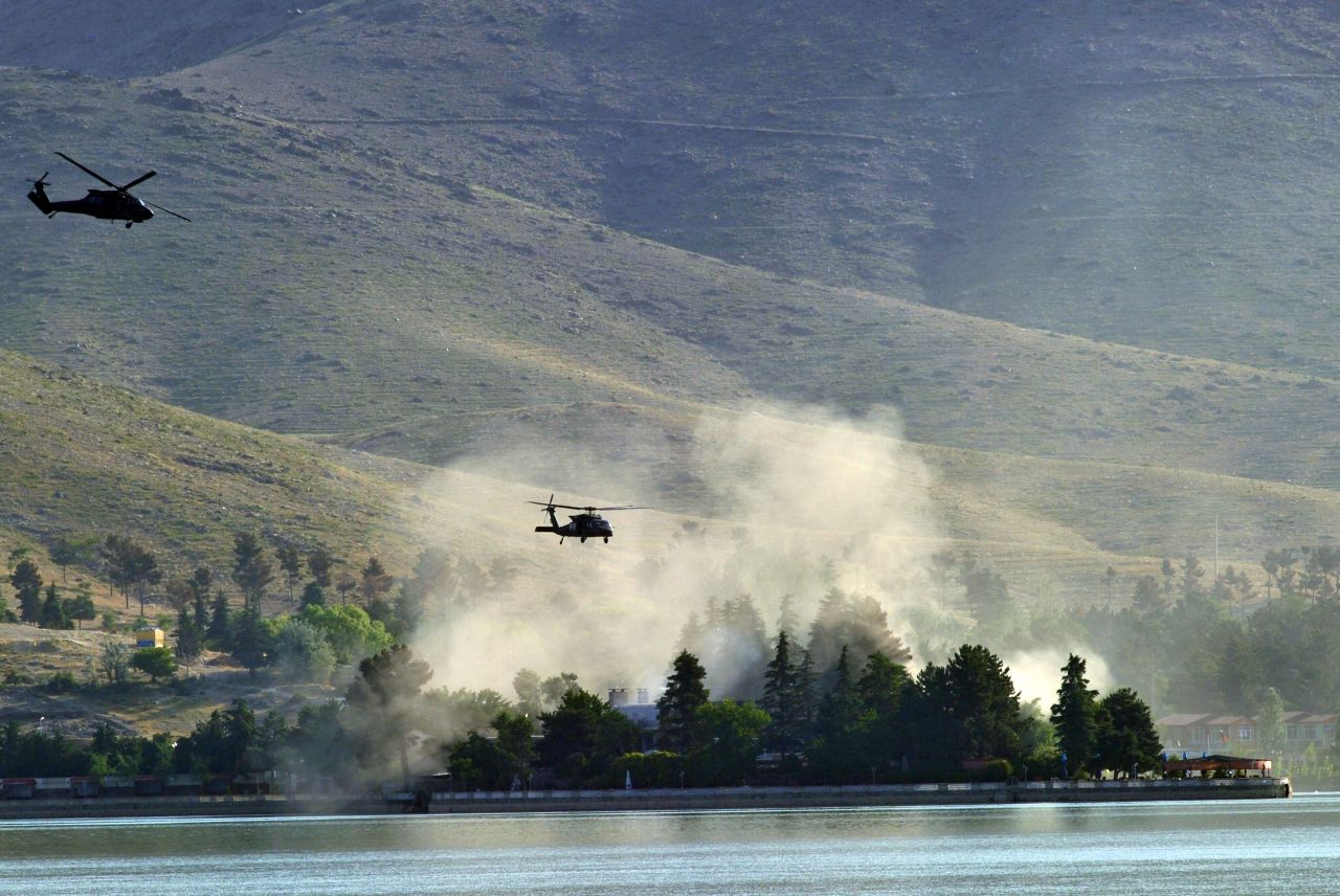 NATO Black Hawk helicopters fly near the Spozhmai Hotel near Kabul on Friday, June 22. Taliban militants attacked the hotel Friday and seized dozens of hostages, sparking a fierce gunbattle with Afghan and NATO troops that left 26 people dead, authorities said.