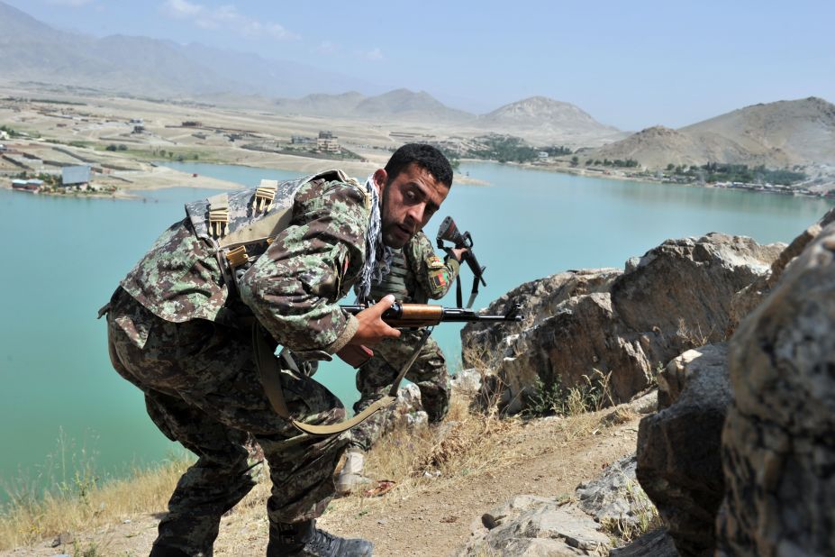 Afghan National Army soldiers stake out positions on a hill near the hotel Friday. The standoff, which lasted 11 hours, ended with the deaths of seven militants, police said.