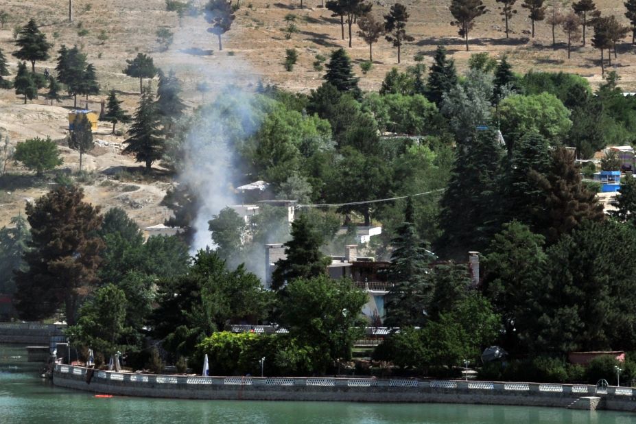 Smoke rises from the hotel where police eventually rescued 50 civilians who had been held hostage.
