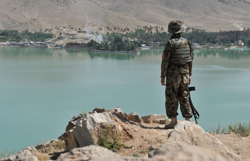 An Afghan soldier looks across Qargha Lake at the hotel. 