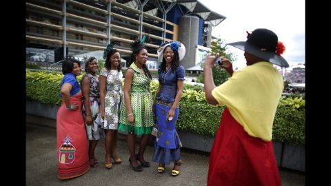 A visitor to Royal Ascot photographs her friends. 