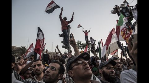 Protesters wave flags and shout slogans in Tahrir Square on Friday, June 22, in Cairo.