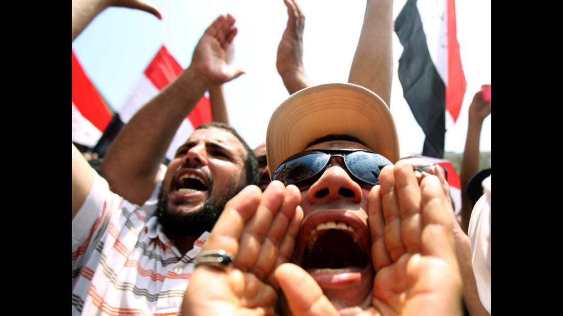 Protesters shout slogans to denounce what they claim is a power grab by the ruling military, as the nation nervously awaits the results of the first post-Mubarak presidential election.