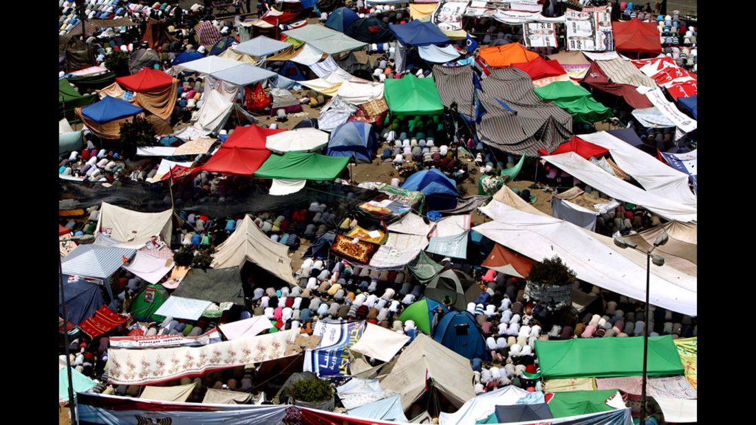 Protesters perform Friday noon prayer under tents erected in Cairo's landmark Tahrir Square.