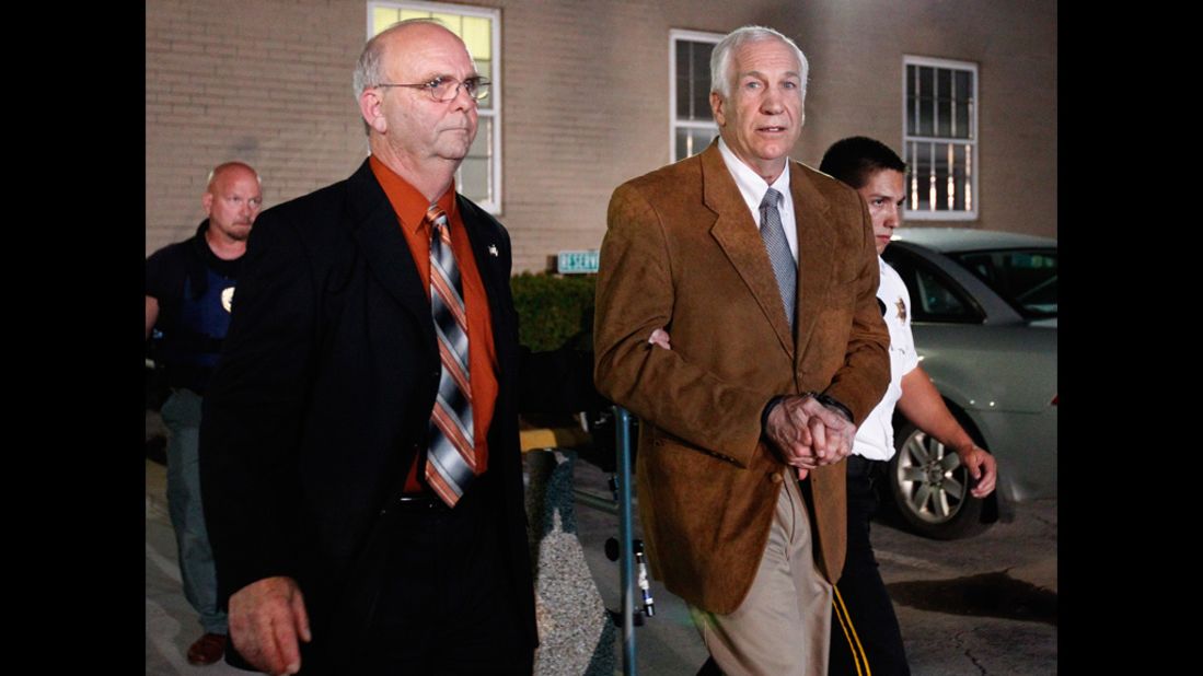 Sandusky faces the cameras as he is led to a sheriff's vehicle in handcuffs after the reading of the verdict.
