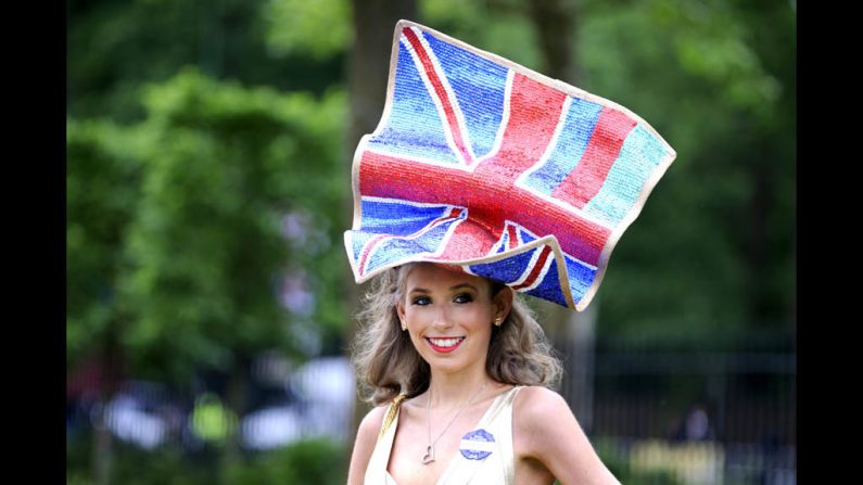 A large hat resembling the British flag sits atop a woman's head.