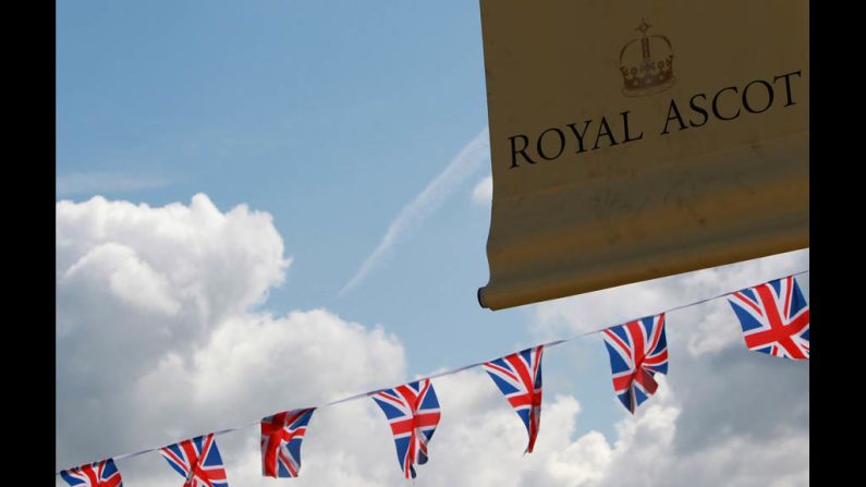 A sign and flags hang in the air.
