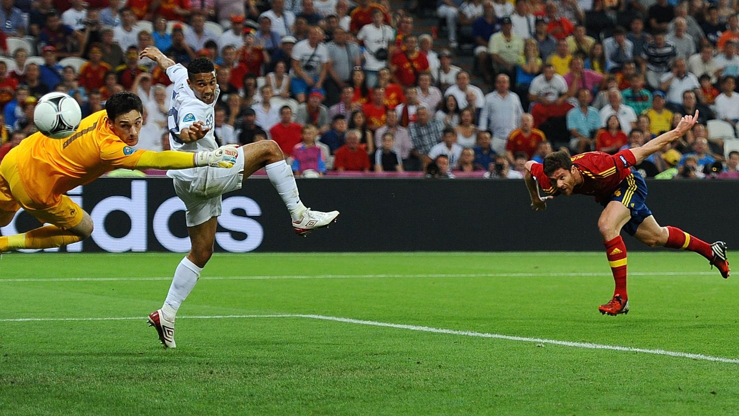 Xabi Alonso (right) heads past goalkeeper Hugo Lloris to open Spain's account in the quarterfinal against France on Saturday