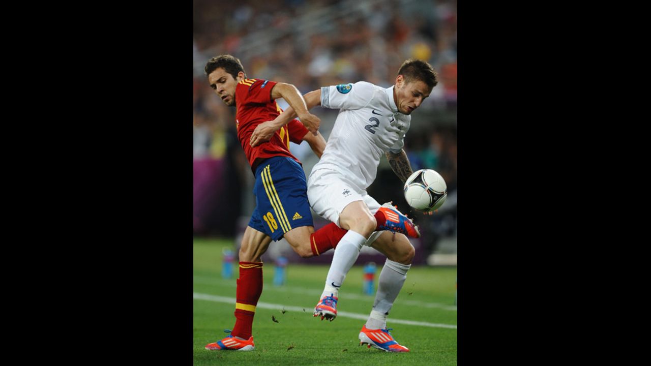 Jordi Alba of Spain in action with Mathieu Debuchy of France.