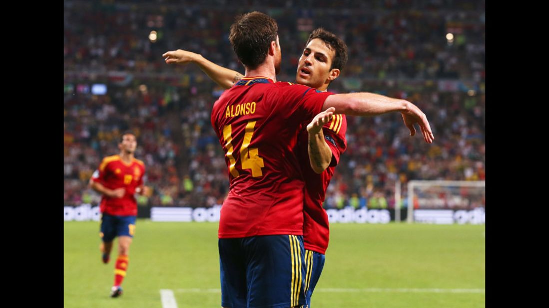 Xabi Alonso of Spain celebrates after scoring the first goal with Cesc Fabregas during Spain's quarterfinal match against France.