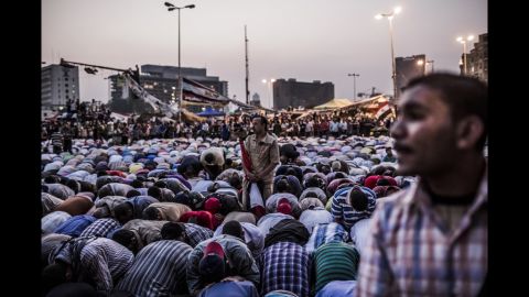 Protesters take a break from shouting slogans to pray in Tahrir Square.