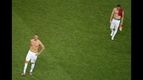 Karim Benzema and Franck Ribery of France look dejected after defeat during the quarter final match between Spain and France.