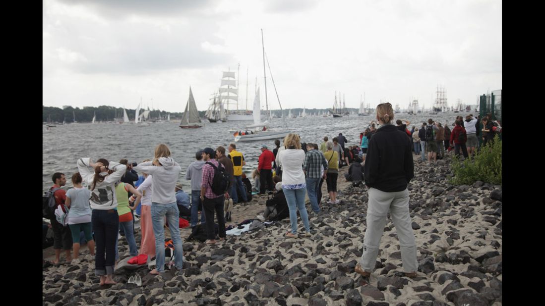 Visitors watch the parade, the highlight of the weeklong Kieler Woche annual sailing festival, which this year is celebrating its 130th anniversary. It ends Sunday.