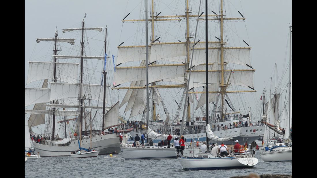 Tall ships participating in the Windjammer Parade head out to sea. 